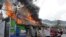 A building burns, set afire by protesters in Port-au-Prince, Haiti, Sept. 27, 2019. Thousands seeking to oust President Jovenel Moise attacked businesses and government buildings across Haiti, fed up with a lengthy shutdown of vital services.