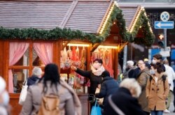 People wearing protective face masks are seen at Schloss Strasse shopping street, amid the COVID-19 outbreak in Berlin, Germany, Dec. 1, 2020.