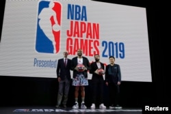 NBA Commissioner Adam Silver, Houston Rockets' P. J. Tucker, Toronto Raptors' Fred VanVleet and Rakuten, Inc. Chairman & CEO Mickey Mikitani, pose for a photo during a welcome reception for the NBA Japan Games 2019