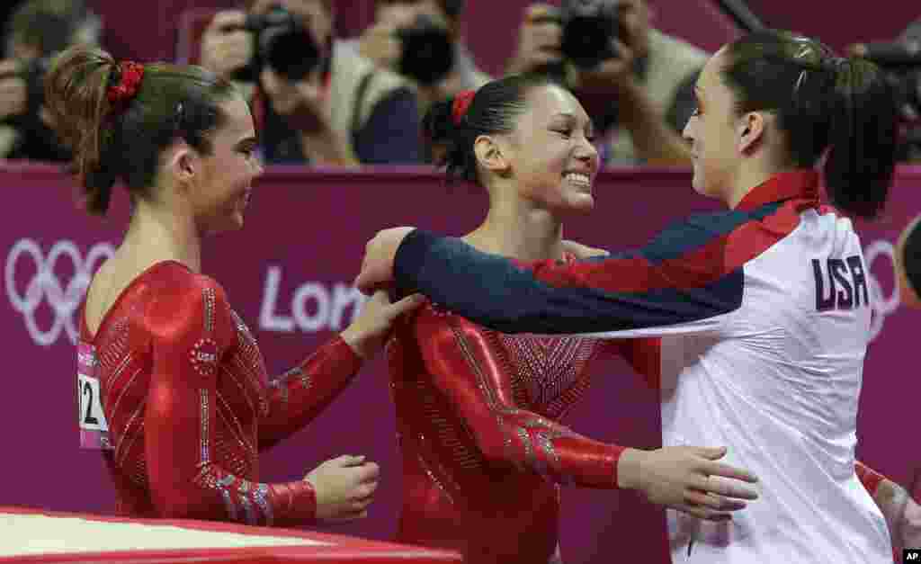 U.S. gymnast Kyla Ross, center, hugs teammate U.S. gymnast Jordyn Wieber during the Artistic Gymnastics women's team final at the 2012 Summer Olympics, July 31, 2012, in London. 