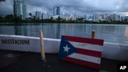 FILE - A wooden Puerto Rican flag is displayed on the dock of the Condado lagoon in San Juan, Puerto Rico, Sept. 30, 2021.