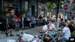 신종 코로나바이러스 감염증(COVID-19) 봉쇄조치가 3개월 이상 지속됐던 뉴욕시에서 제2단계 경제활동을 재개한 가운데 식당가에서 시민들이 저녁 식사를 하고 있다. 