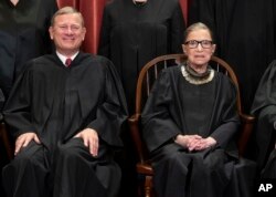 Justice Ruth Bader Ginsburg with Chief Justice John Roberts during a formal group portrait at the Supreme Court in Washington, Nov. 30, 2018.