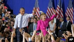 President Barack Obama and Democratic presidential candidate Hillary Clinton wave to the crowd during a campaign rally for Clinton in Charlotte, N.C., July 5, 2016.