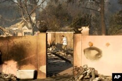 Eric Durtschi surveys the remains of home, leveled by the Holiday fire, in Goleta, Calif., July 7, 2018.