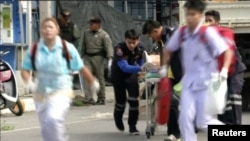 Rescuers and medical officers push an injured person on a gurney at the site of a bomb blast in Hua Hin, south of Bangkok, Thailand, in this still image taken from video, August 12, 2016.