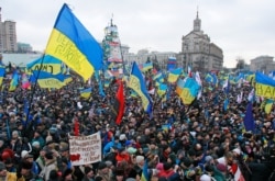FILE - People attend a rally at Maidan Nezalezhnosti, or Independence Square, in central Kyiv, Dec. 8, 2013.