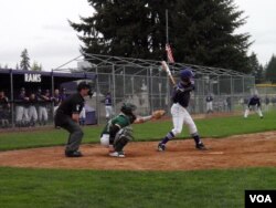 Timberline High School players in Lacey, Washington, used the axe bat in warmups, but stayed with the traditional bats for the actual game. (T. Banse/VOA).