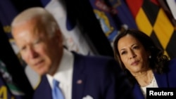 Democratic vice presidential candidate Senator Kamala Harris looks on as Joe Biden speaks