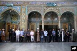 Iranian men queue to vote for the presidential and municipal councils elections, in the city of Qom, south of the capital Tehran, Iran, May 19, 2017.