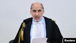 Court President Alfredo Montalto delivers the verdict in the case of an alleged people-smuggling kingpin identified as Medhanie Yehdego Mered, who said he was not the man authorities sought, in Palermo, Italy, July 12, 2019.