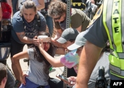 People receive first-aid after a car accident ran into a crowd of protesters in Charlottesville, VA, Aug. 12, 2017.