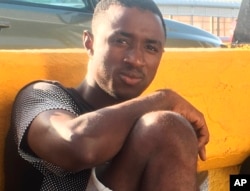 Mamadou Aliou Barry, who departed from his native Guinea in West Africa when he was 14, a few years ago, waits for entry to the U.S. on the Gateway Bridge in Matamoros, Mexico, which connects to Brownsville, Texas, July 3, 2018. He said as part of the minority ethnic Fula group, he fears for his life and carries prints of a picture of him and a friend together and a picture of his friend after he was slain, for his asylum interview.