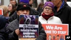 Protesters display placards during a rally called "We Will Persist" in Boston, Feb. 21, 2017.