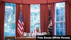 President Barack Obama talks on the phone with Cuba President Raúl Castro in the Oval Office, Sept. 18, 2015.