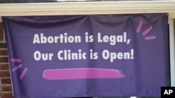 FILE - A signs hangs outside the Whole Women's Health Clinic in Fort Worth, Texas, Sept. 1, 2021. A Texas law banning most abortions in the state took effect at midnight that day.