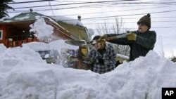 Residents clear snow in Lonquimay, Araucania Region, located 730 kilometers south of Santiago, Chile, July 20, 2011