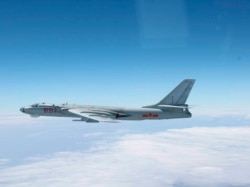 A Chinese military plane H-6 bomber flies through airspace between Okinawa prefecture's main island and the smaller Miyako island in southern Japan, photo taken Oct. 27, 2013.