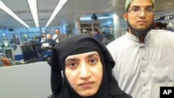 This July 27, 2014 photo provided by U.S. Customs and Border Protection shows Tashfeen Malik, left, and Syed Farook, as they passed through O'Hare International Airport in Chicago.