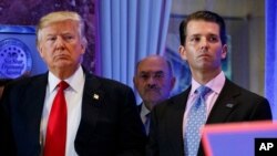 FILE - former President Donald Trump, left, his chief financial officer Allen Weisselberg, center, and son Donald Jr.