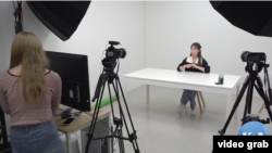 Kang Nara prepares to film a YouTube video from her Seoul studio (video screengrab via VOA News)
