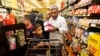 Nadim Fawzi Jouriyeh, a Syrian refugee who arrived recently in the United States with his wife and four children, puts items in a cart while shopping with his son, Farouq Nadim Jouriyeh, in El Cajon, Calif., Aug. 31, 2016.
