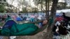 A Thai man sleeps in a park with fellow protesters in central Bangkok, Jan. 14, 2014. 