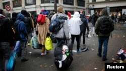 Migrants as they transfer to reception centers across the country during the dismantlement of makeshift camps, Stalingrad metro station, Paris, France, Nov. 4, 2016.
