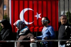 FILE - People wait outside the Turkish consulate in Berlin, March 27, 2017 to cast their votes on the first day of the referendum on the presidential system in Turkey.