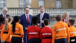 Britain's Prince Harry gestures in the gardens of Buckingham Palace in London, Thursday, Jan. 16, 2020. Prince Harry, the Duke of Sussex will host the Rugby League World Cup 2021 draw at Buckingham Palace, prior to the draw.