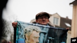 French fan Andre Duval displays a portrait of Johnny Hallyday outside his house in Marnes-la-Coquette, outside Paris, Dec.6, 2017.