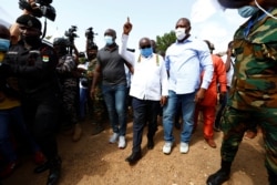 Ghana's President Nana Akufo-Addo gestures at a polling station during presidential and parliamentary elections in Kyebi, Ghana, Dec. 7, 2020.