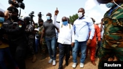 Ghana's President Nana Akufo-Addo gestures at a polling station during presidential and parliamentary elections in Kyebi, Ghana, Dec. 7, 2020.