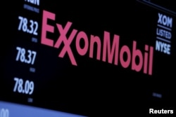 FILE - The logo of ExxonMobil Corporation is shown on a monitor above the floor of the New York Stock Exchange in New York, Dec. 30, 2015.