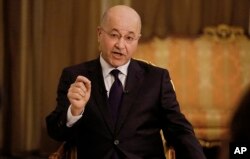 Iraq's President Barham Salih speaks during an interview with The Associated Press in Baghdad, Iraq, March 29, 2019.