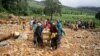 FILE - Men carry a coffin on along a makeshift path on the river in Ngangu township Chimanimani, Manicaland province, eastern Zimbabwe, after the area was hit by Cyclone Idai.