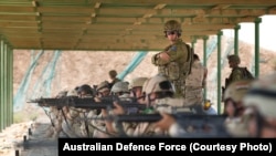 Task Group Taji Australian Army trainer Corporal Benjamin Wallis instructs regular Iraqi Army soldiers during a live-fire range shoot at the Taji Military Complex in Iraq.