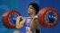 FILE - Shahin Nasirinia of Iran lifts in the clean and jerk during the men's 207 lb (94 kg) event at the Nikaia Olympic Weightlifting Hall during the Summer Olympics in Athens, Monday Aug. 23, 2004.