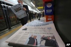 A newspaper with headline telling of a planned summit meeting between North Korean leader Kim Jong Un and U.S. President Donald Trump is displayed at a subway station in Seoul, South Korea, March 10, 2018.