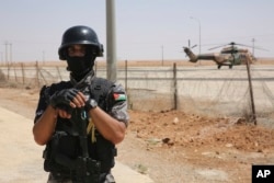 A Jordanian soldier stands guard at the Iraq-Jordan border, Aug. 30, 2017, at the Jordanian Karameh border crossing.