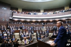 Turkey's President Recep Tayyip Erdogan, talks to members of the ruling Justice and Development party in Ankara, Turkey, June 13, 2017. Erdogan reiterated his country's position to support Qatar.