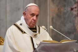 FILE - Pope Francis celebrates Easter Sunday Mass, inside an empty St. Peter's Basilica at the Vatican, April 12, 2020.