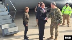 FILE - U.S. Defense Secretary Ash Carter greets Army Lt. Gen. Sean MacFarland after arriving in Baghdad, Dec. 16, 2015. Carter is on a weeklong trip to the Middle East. 