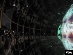 Mirrors surrounding the screen make the viewer a part of Theo Eshetu’s “Brave New World I.”