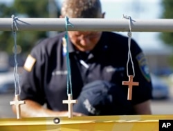 A police chaplain pays his respects July 18, 2016, at a makeshift memorial at the fatal shooting scene in Baton Rouge, Louisiana, where three law enforcement officers were ambushed and killed by a lone gunman on Sunday.