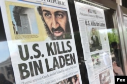 FILE - Front-page headlines that announce the death of al-Qaida terror leader Osama bin Laden are seen at the Newseum in Washington, May 2, 2011.