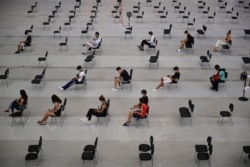 FILE - People wait 15 minutes after receiving the Pfizer COVID-19 vaccine during national COVID-19 vaccination campaign in Pamplona, northern Spain, Sept. 2, 2021.