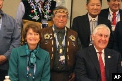 U.S. Secretary of State Rex Tillerson (seated right) and U.S. Sen. Lisa Murkowski pose with Nulato Chief Mickey Stickman at an Arctic Council event in Fairbanks, Alaska.