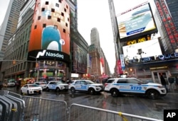 A row of New York City police cars is parked along a street in Times Square, Dec. 29, 2016, in New York.