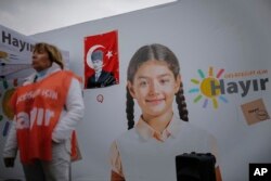A woman stands in front of billboard that reads "NO for my future" in Istanbul, April 4, 2017. Turkey is heading to a contentious April 16 referendum on constitutional reforms to expand President Recep Tayyip Erdogan's powers.